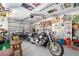 Spacious garage featuring motorcycles, tools, storage, and unique decor, perfect for hobbyists at 14 Marsh Ct, Ponce Inlet, FL 32127