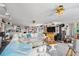 Expansive living room with a large sectional couch, fireplace, ceiling fans and an open layout to the kitchen at 14 Marsh Ct, Ponce Inlet, FL 32127