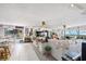 Open living room with tile flooring, a comfortable couch, and large windows offering panoramic views at 14 Marsh Ct, Ponce Inlet, FL 32127