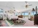 Spacious main bedroom featuring ceiling fans, deck access, and scenic views through large windows at 14 Marsh Ct, Ponce Inlet, FL 32127