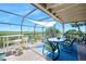 Outdoor patio features ample seating, blue rug, and view of native foliage at 14 Marsh Ct, Ponce Inlet, FL 32127