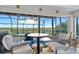Relaxing screened patio with comfortable seating and a view of the natural landscape at 14 Marsh Ct, Ponce Inlet, FL 32127