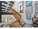 Staircase with carpeted steps and wooden banister, adorned with art and bathed in natural light at 14 Marsh Ct, Ponce Inlet, FL 32127