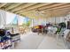 A sun room featuring white carpet, a ceiling fan, and a multitude of stored items at 14 Marsh Ct, Ponce Inlet, FL 32127