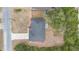 Overhead view of a single-story home with a dark roof and a concrete driveway surrounded by trees at 1435 6Th Ave, Deland, FL 32724