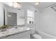 Bright bathroom features a granite countertop, ample lighting, and shower over the tub at 1435 6Th Ave, Deland, FL 32724