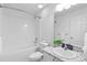 A bathroom features a shower-tub combination, modern vanity, and neutral walls at 1435 6Th Ave, Deland, FL 32724