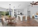 Dining area featuring wood floors, white walls, a modern chandelier, and a kitchen with granite counters at 1435 6Th Ave, Deland, FL 32724