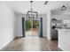 Bright dining area featuring wood floors, white walls, and sliding doors with blue curtains at 1435 6Th Ave, Deland, FL 32724