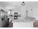 Bright kitchen featuring stainless steel appliances, granite countertops, white cabinets and modern lighting at 1435 6Th Ave, Deland, FL 32724