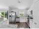 The kitchen features stainless steel appliances, granite counters and a view of the backyard at 1435 6Th Ave, Deland, FL 32724