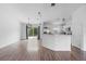 Open-concept living space features wood floors, white walls, and stainless steel appliances at 1435 6Th Ave, Deland, FL 32724