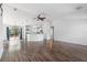 Open-concept living space features wood floors, white walls, and a granite counter kitchen area at 1435 6Th Ave, Deland, FL 32724