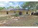 View of the house's back exterior showing the patio and the lush backyard space at 1450 14Th St, Orange City, FL 32763