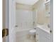 Bathroom featuring tub/shower combo, white vanity and tiled floors at 1450 14Th St, Orange City, FL 32763