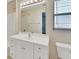 Bright bathroom features a large mirror, great lighting, and a white vanity at 1450 14Th St, Orange City, FL 32763