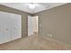 Bedroom features a ceiling fan, double closets, and carpeted floors at 1450 14Th St, Orange City, FL 32763