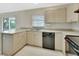 Well-lit kitchen with ample counter space, black appliances, and view to the outside at 1450 14Th St, Orange City, FL 32763
