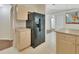 Kitchen with modern black refrigerator, neutral cabinets, and ample counter space at 1450 14Th St, Orange City, FL 32763