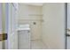 Cozy laundry room with tile floors, washer, dryer and wire shelving for optimal organization at 1450 14Th St, Orange City, FL 32763