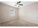This bedroom features neutral walls, carpet, a window with blinds, and a ceiling fan at 1480 Leitrim Loop, Apopka, FL 32703