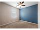 This bedroom features carpet, neutral walls with a pop of blue, and a ceiling fan at 1480 Leitrim Loop, Apopka, FL 32703