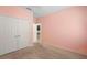 This bedroom has carpet, pink walls, double closet, and a ceiling fan at 1480 Leitrim Loop, Apopka, FL 32703