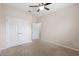 This bedroom has carpet, neutral walls, double closet, and a ceiling fan at 1480 Leitrim Loop, Apopka, FL 32703