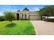 Charming home featuring a brick driveway, two car garage, a well-manicured lawn and shuttered windows at 1480 Leitrim Loop, Apopka, FL 32703