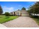 Charming home featuring a brick driveway, two car garage, a well-manicured lawn and shuttered windows at 1480 Leitrim Loop, Apopka, FL 32703