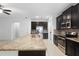 Modern kitchen featuring dark cabinets, stainless steel appliances, granite counters, and a large island at 1480 Leitrim Loop, Apopka, FL 32703