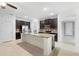 Spacious kitchen features dark cabinets, stainless steel appliances, granite counters, and a large island at 1480 Leitrim Loop, Apopka, FL 32703