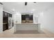 Open kitchen showcasing a large island with granite countertop, dark cabinets, and stainless steel appliances at 1480 Leitrim Loop, Apopka, FL 32703