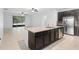 Open kitchen with granite countertops, stainless steel appliances, and dark wood cabinets at 1480 Leitrim Loop, Apopka, FL 32703
