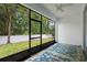Enclosed lanai with patterned carpet and views of the backyard at 1480 Leitrim Loop, Apopka, FL 32703