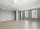 Large living area with neutral walls, tile flooring, two large windows, and a ceiling fan at 1480 Leitrim Loop, Apopka, FL 32703