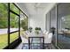 Covered porch features large table with 6 chairs, overhead ceiling fan, and sliding glass doors at 1480 Leitrim Loop, Apopka, FL 32703