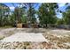 Large backyard featuring outbuildings and a sandy area perfect for recreation or building your dream outdoor oasis at 1560 7Th Ave, Deland, FL 32724