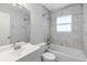 Bathroom featuring a single vanity, a tub/shower combo, and marble tile at 1560 7Th Ave, Deland, FL 32724