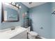 Cozy bathroom with modern vanity, decor, and blue wall at 1560 7Th Ave, Deland, FL 32724