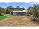 Charming two-story home with a metal roof, front porch, and palm tree at 1560 7Th Ave, Deland, FL 32724