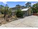 Charming two-story home with a metal roof and cracked driveway at 1560 7Th Ave, Deland, FL 32724