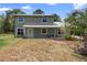Charming two-story home with a covered porch and mature palm trees at 1560 7Th Ave, Deland, FL 32724