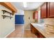 Traditional kitchen with tile backsplash, view to living area, and wood cabinets at 1560 7Th Ave, Deland, FL 32724