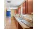 Traditional kitchen featuring tile backsplash, double sink, and view to the living area at 1560 7Th Ave, Deland, FL 32724