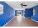 Spacious living room featuring tile flooring, ceiling fan, and sliding glass doors at 1560 7Th Ave, Deland, FL 32724
