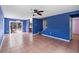 Open living room with tile floors, a ceiling fan, and a view of the backyard through sliding doors at 1560 7Th Ave, Deland, FL 32724