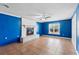 Living room featuring a white brick fireplace and bright blue accent wall at 1560 7Th Ave, Deland, FL 32724