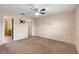 Main bedroom with carpet, ceiling fan, and entry to the ensuite bathroom at 1560 7Th Ave, Deland, FL 32724
