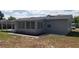 Exterior view of home with a covered patio and lush greenery at 1626 S Page Dr, Deltona, FL 32725